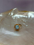Anillo Larimar corte Oval acabado dorado con zircones